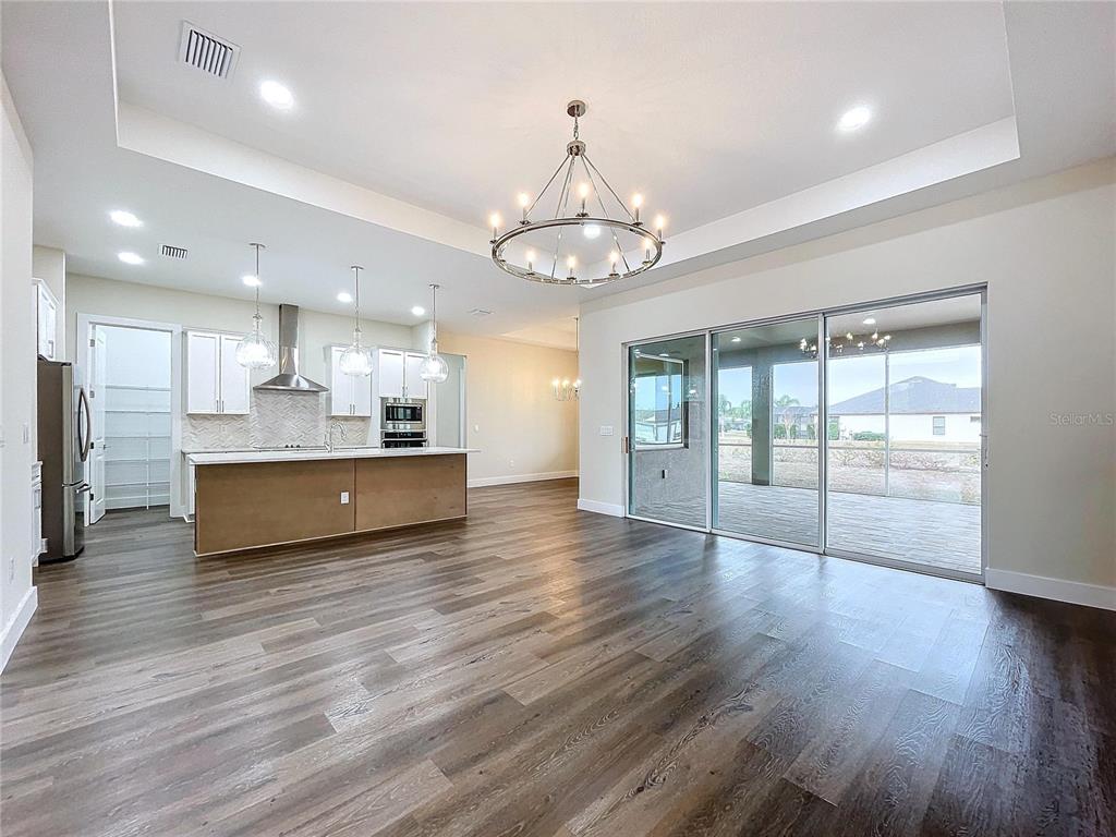 9065 Mississippi Run Weeki Wachee, FL 34613 - Photo 5 of 86 a view of a big room with wooden floor and a kitchen