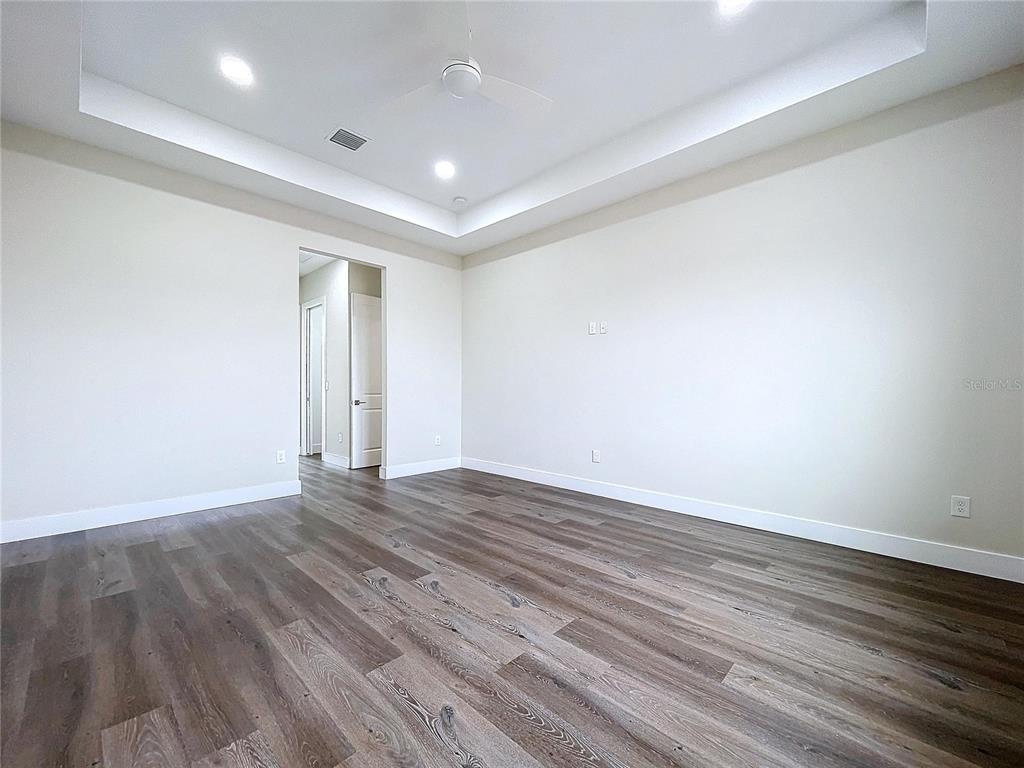 9065 Mississippi Run Weeki Wachee, FL 34613 - Photo 56 of 86 a view of an empty room with wooden floor