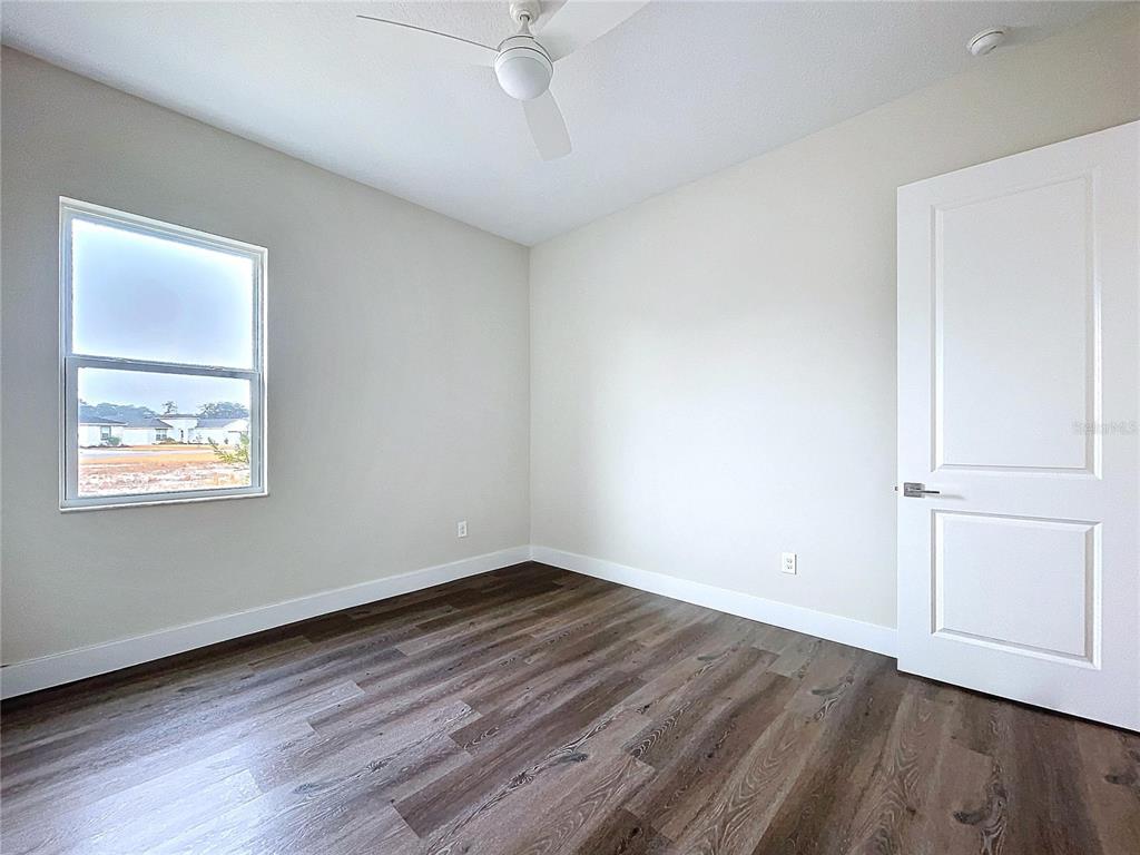 9065 Mississippi Run Weeki Wachee, FL 34613 - Photo 64 of 86 a view of an empty room with wooden floor and a window