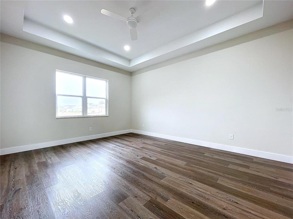 9065 Mississippi Run Weeki Wachee, FL 34613 - Photo 66 of 86 an empty room with wooden floor and windows