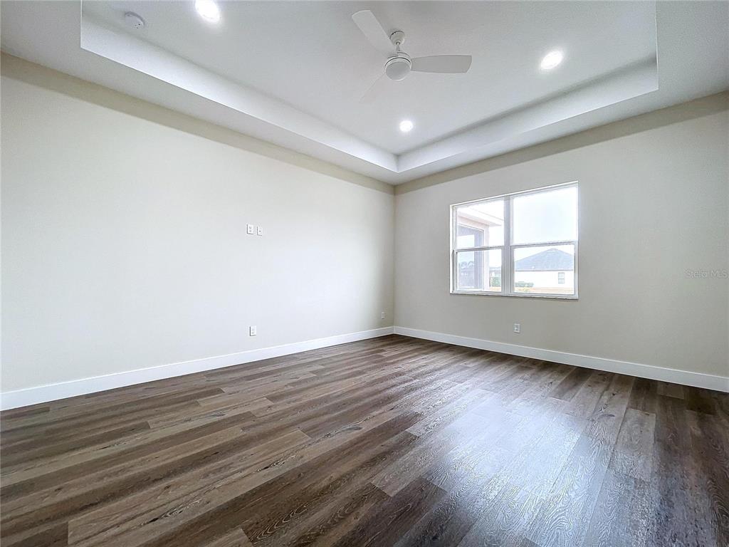 9065 Mississippi Run Weeki Wachee, FL 34613 - Photo 67 of 86 an empty room with wooden floor and windows