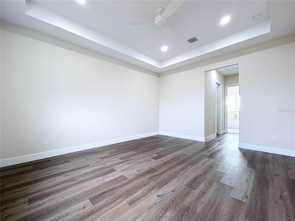9065 Mississippi Run Weeki Wachee, FL 34613 - Photo 68 of 86 a view of an empty room with wooden floor