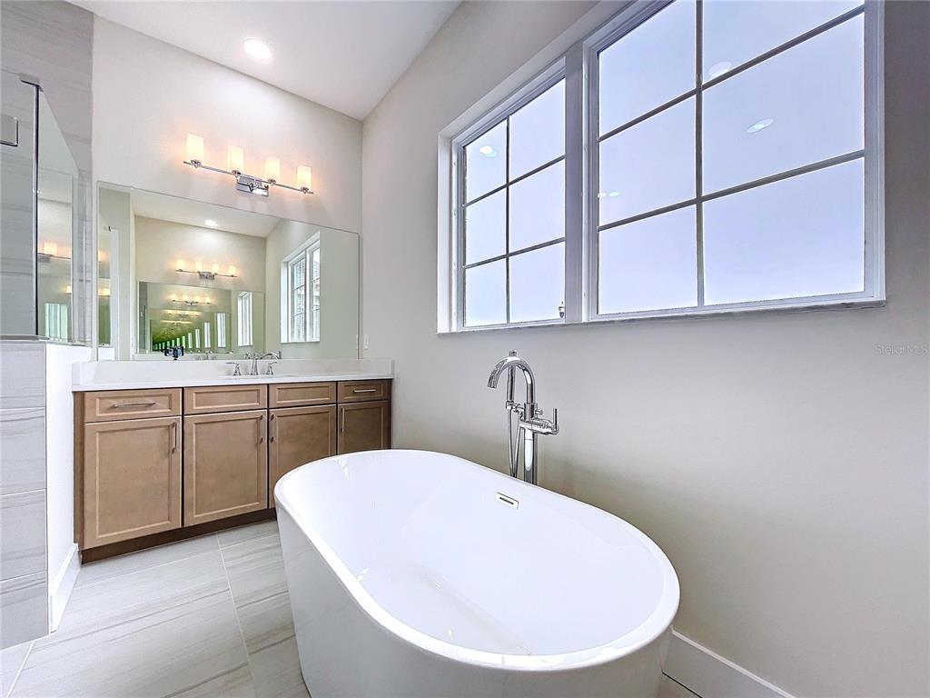 9065 Mississippi Run Weeki Wachee, FL 34613 - Photo 7 of 86 a bathroom with a sink a vanity and mirror