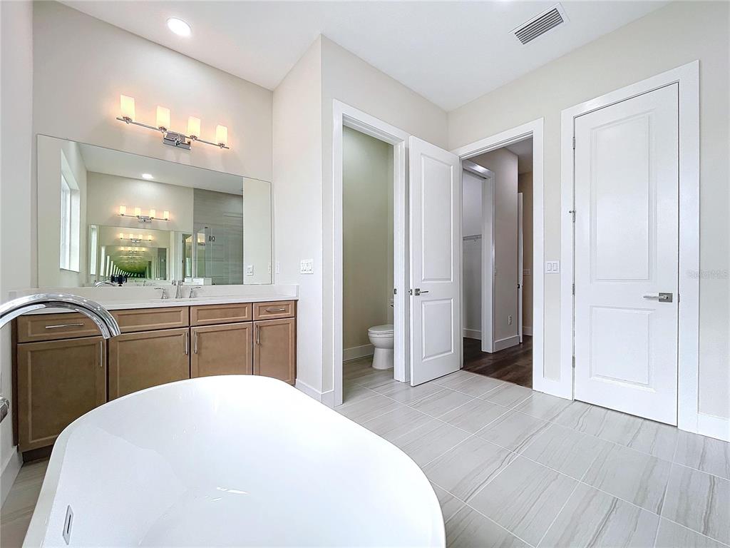 9065 Mississippi Run Weeki Wachee, FL 34613 - Photo 73 of 86 a spacious bathroom with a bathtub sink and mirror