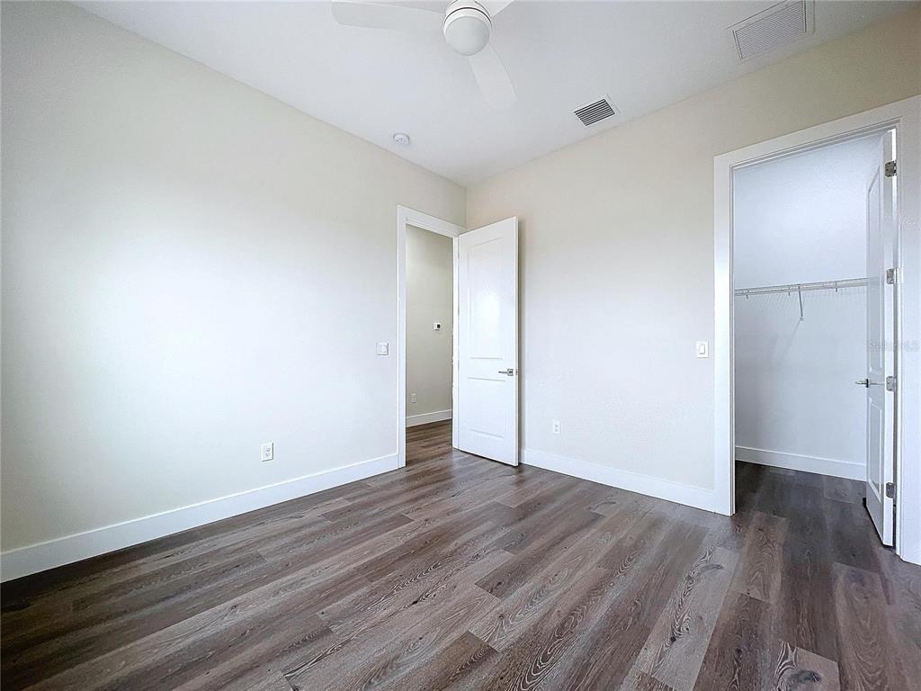 9065 Mississippi Run Weeki Wachee, FL 34613 - Photo 76 of 86 a view of an empty room with wooden floor