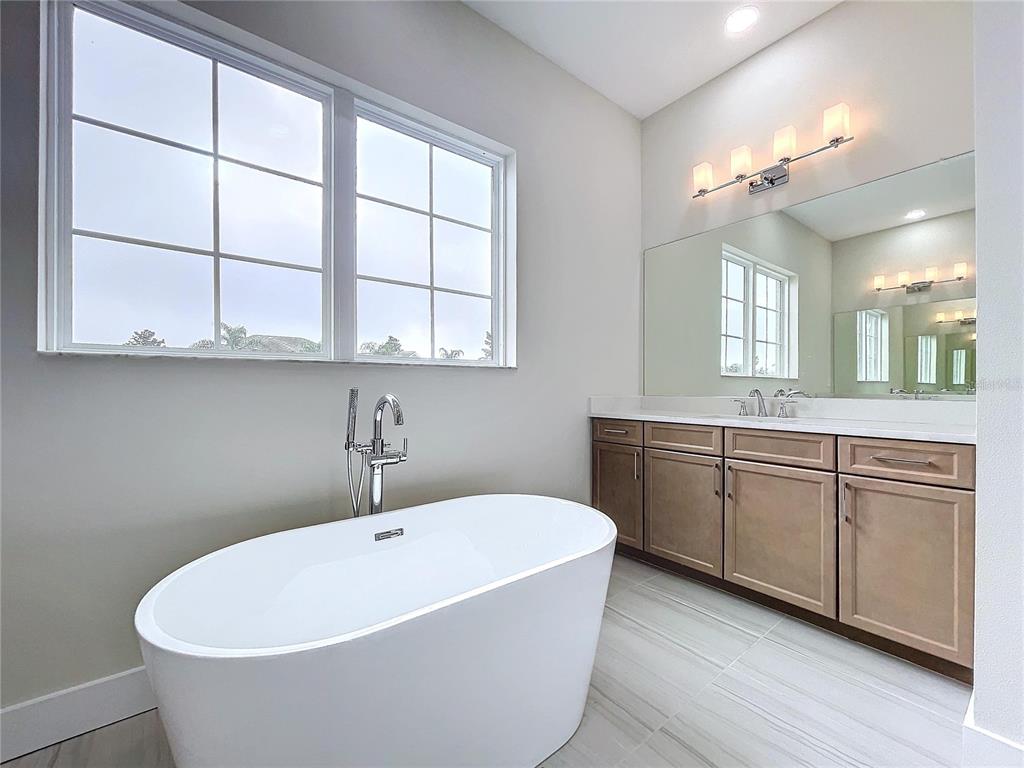 9065 Mississippi Run Weeki Wachee, FL 34613 - Photo 8 of 86 a white bath tub sitting next to a white sink