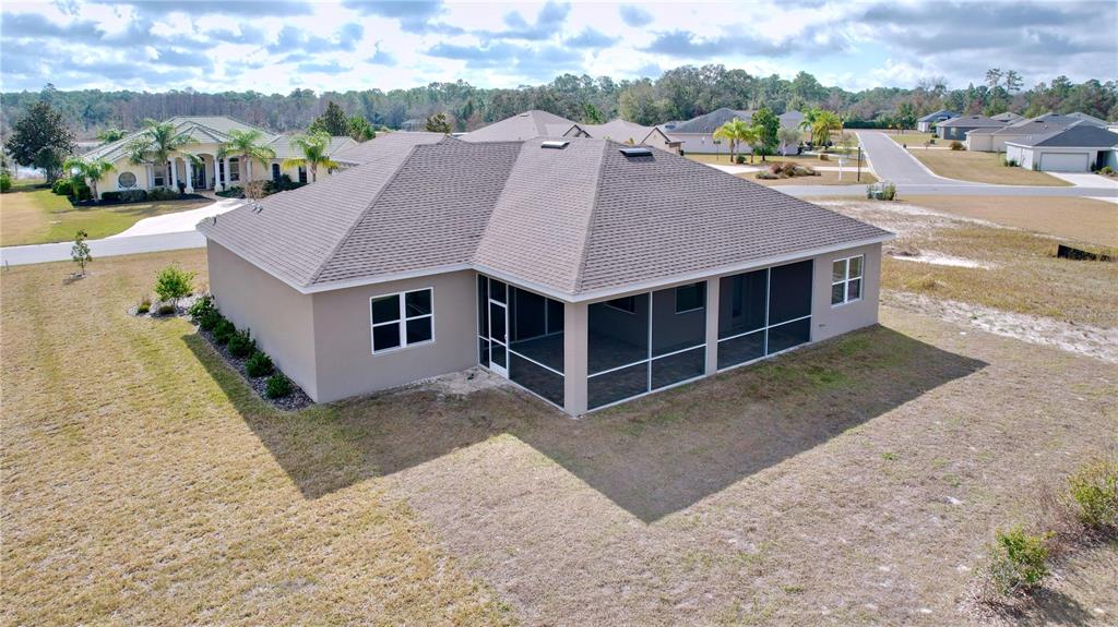 9065 Mississippi Run Weeki Wachee, FL 34613 - Photo 84 of 86 a aerial view of a house with a yard and lake view