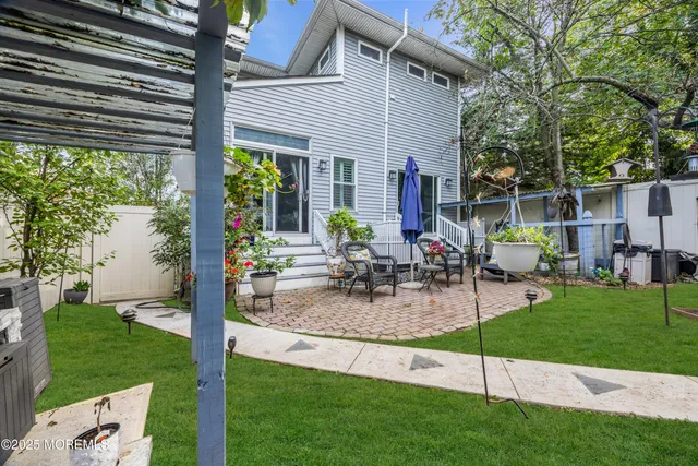 a view of a backyard with plants and a patio