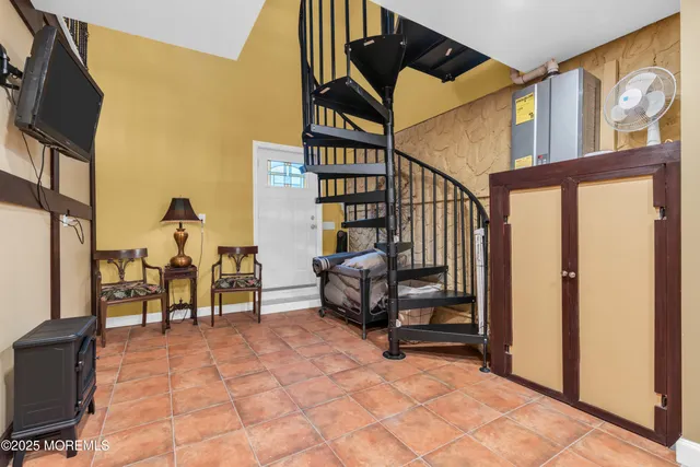 a bed sitting in a bedroom next to a large window