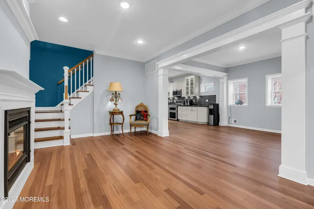 a view of a kitchen with furniture and wooden floor
