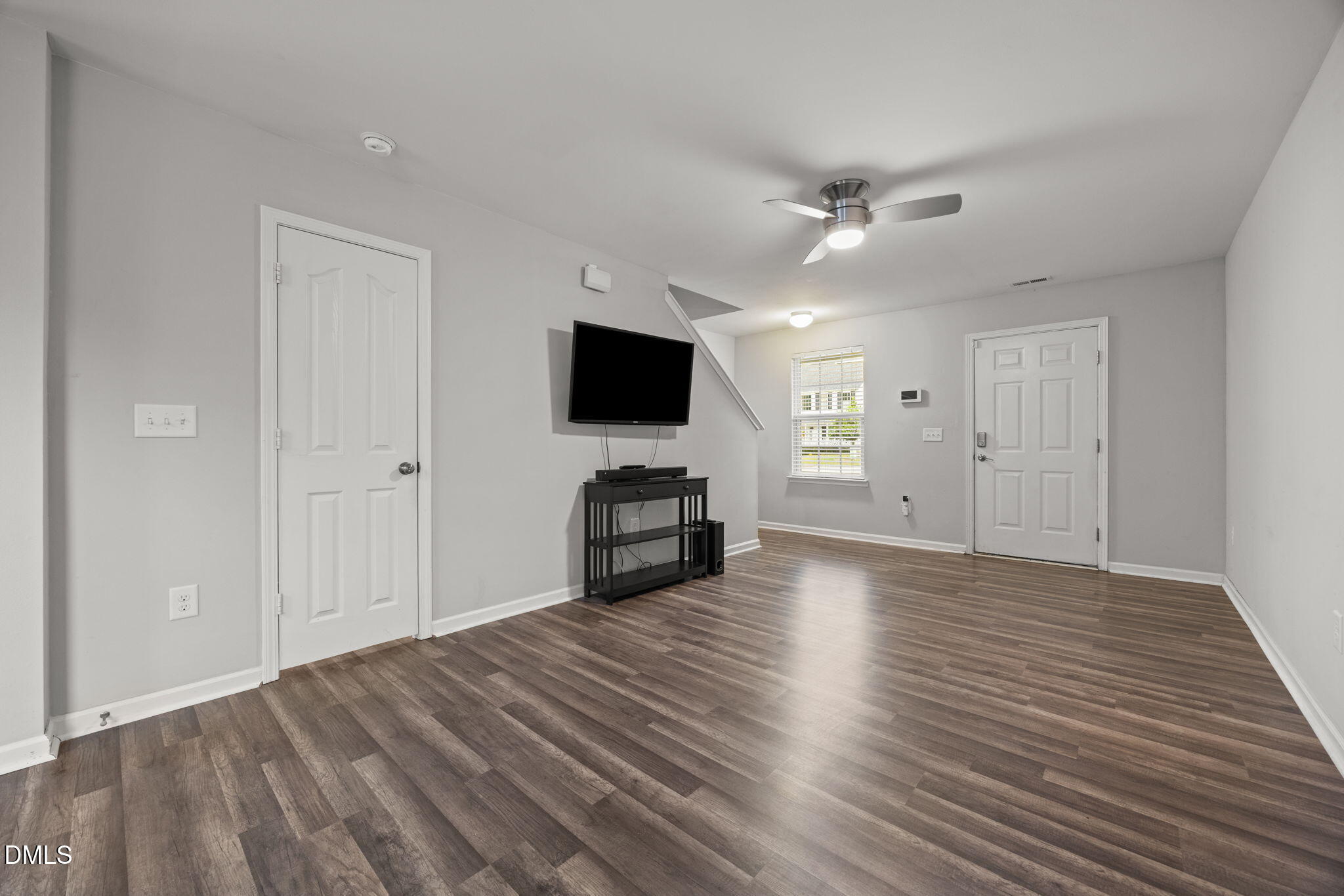 45 Crane Way Bunnlevel, NC 28323 - Photo 6 of 35 a view of a livingroom with a flat screen tv wooden floor and a ceiling fan