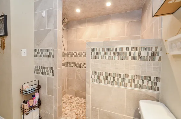 a bathroom with a bathtub and shower