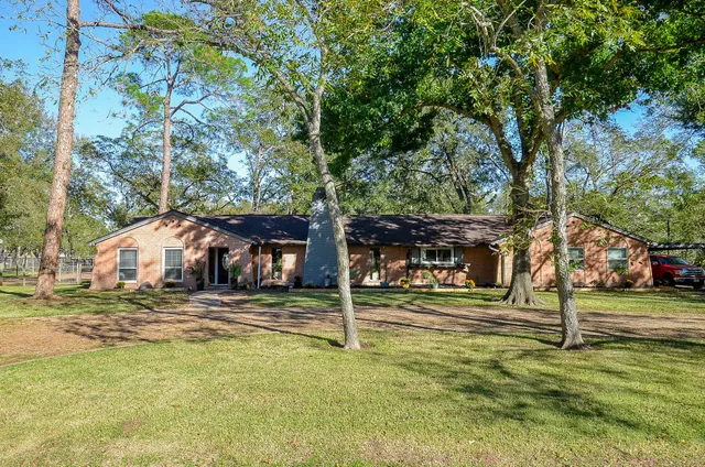 a view of a house with a yard and tree s