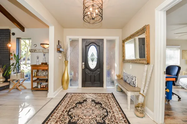 a view of an entryway with wooden floor
