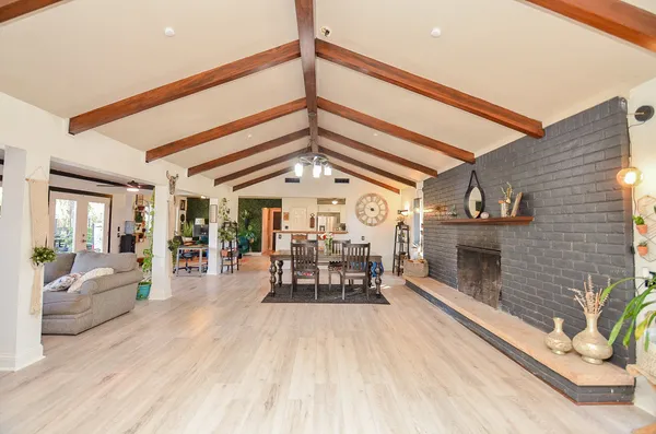 a living room with furniture a fireplace and white walls
