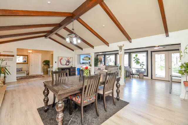 a dining room with furniture window and wooden floor