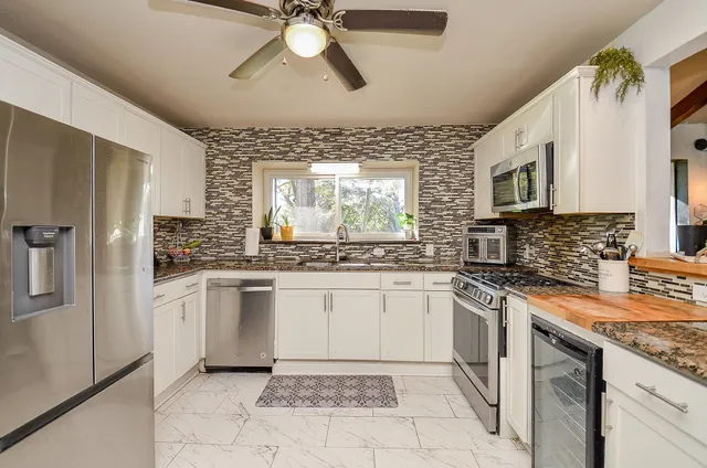 a kitchen with a stove a sink and a refrigerator
