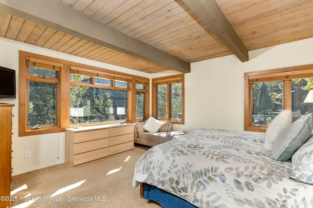 a bedroom with a large bed and a large window