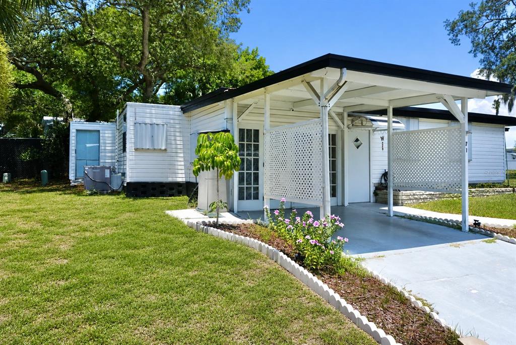 980 7th Street Northwest, Unit 71 Largo, FL 33770 - Photo 3 of 23 a view of a house with a backyard