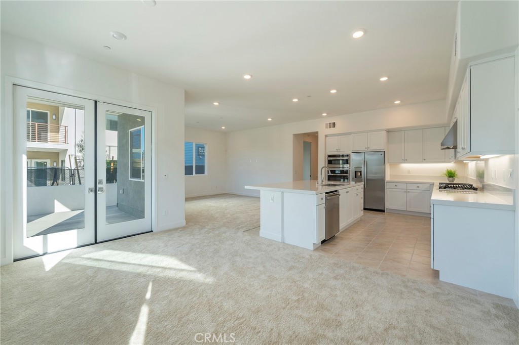 121 Baluster Irvine, CA 92618 - Photo 7 of 80 a view of kitchen with kitchen island and stainless steel appliances