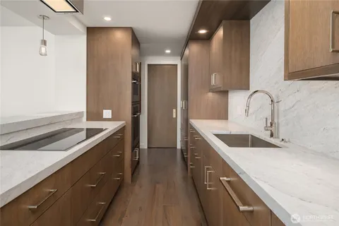 a kitchen with granite countertop a sink and cabinets