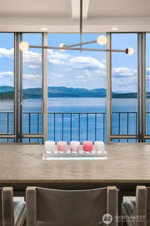 a room with table chairs and windows