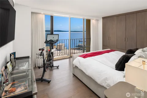 a bed room with a bed and a flat tv screen