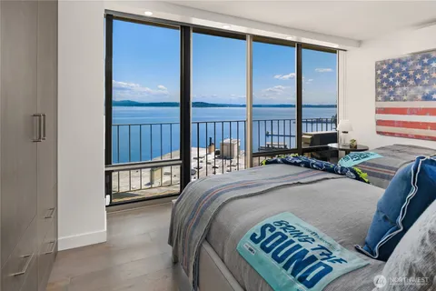 a bed sitting in a bedroom next to a window