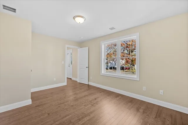 a bathroom with a granite countertop toilet and a sink