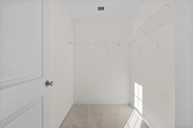 a bathroom with a granite countertop toilet and a sink