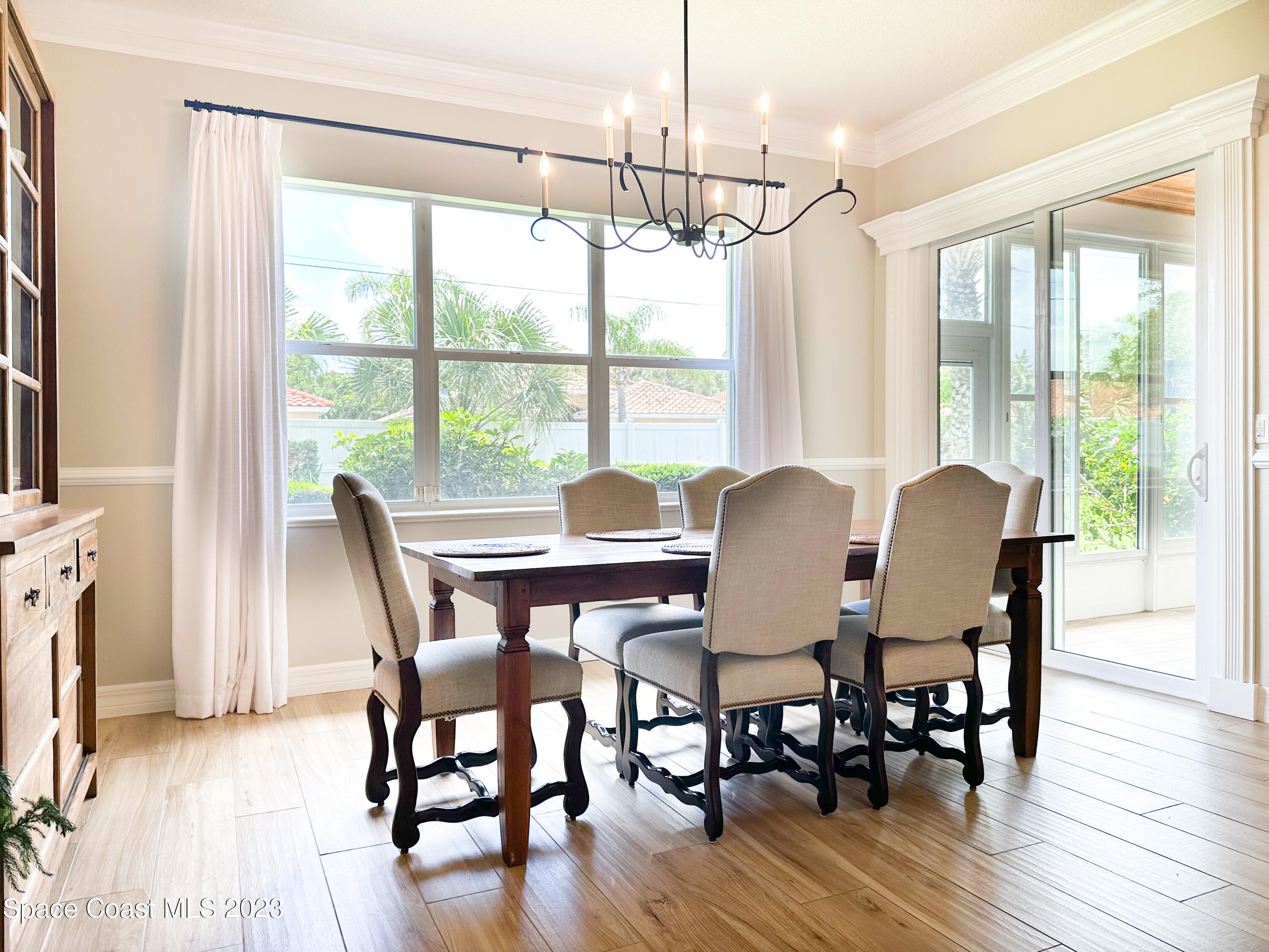 245 Clyde Street Melbourne Beach, FL 32951 - Photo 12 of 88 a view of a dining room with furniture window and wooden floor