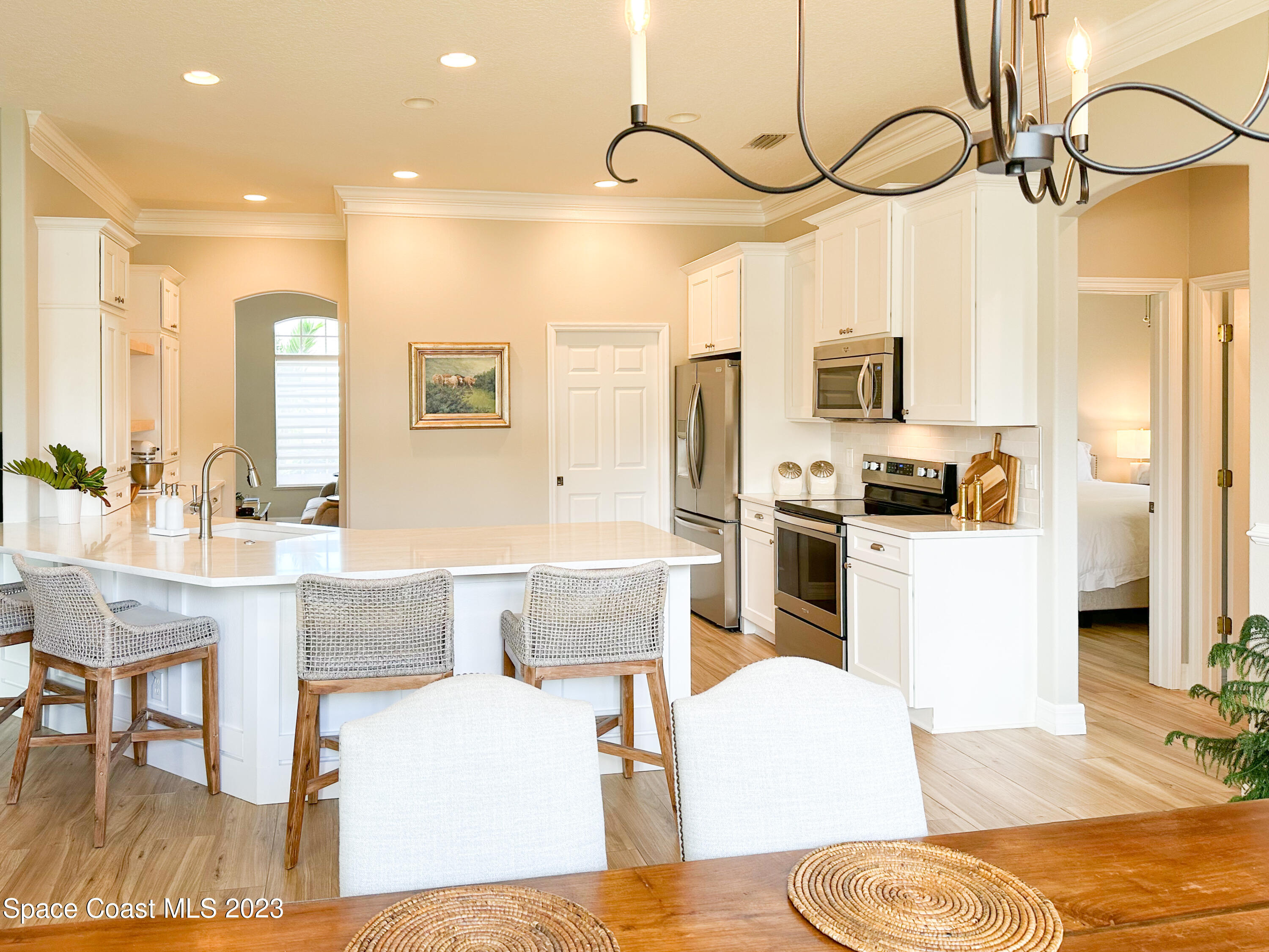 245 Clyde Street Melbourne Beach, FL 32951 - Photo 15 of 88 a living room with stainless steel appliances kitchen island granite countertop furniture and a dining table