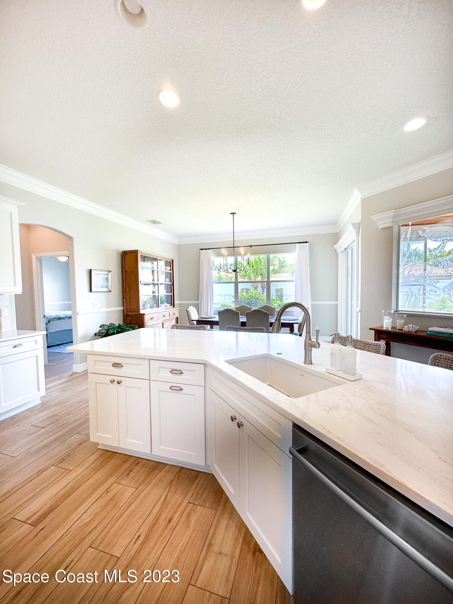 245 Clyde Street Melbourne Beach, FL 32951 - Photo 17 of 88 a large white kitchen with a sink and dishwasher a stove with wooden floor