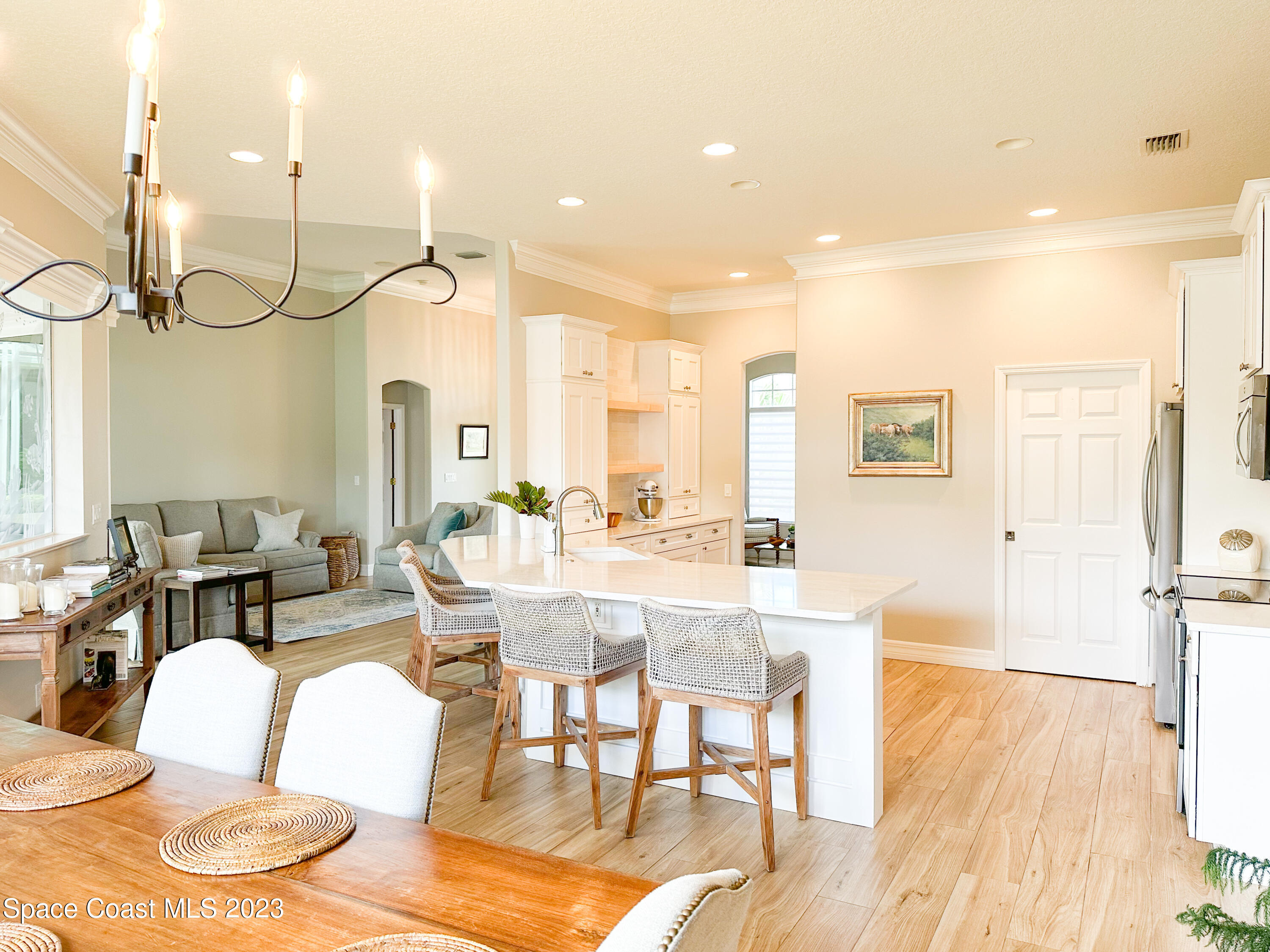 245 Clyde Street Melbourne Beach, FL 32951 - Photo 30 of 88 a living room with furniture kitchen view and a wooden floor