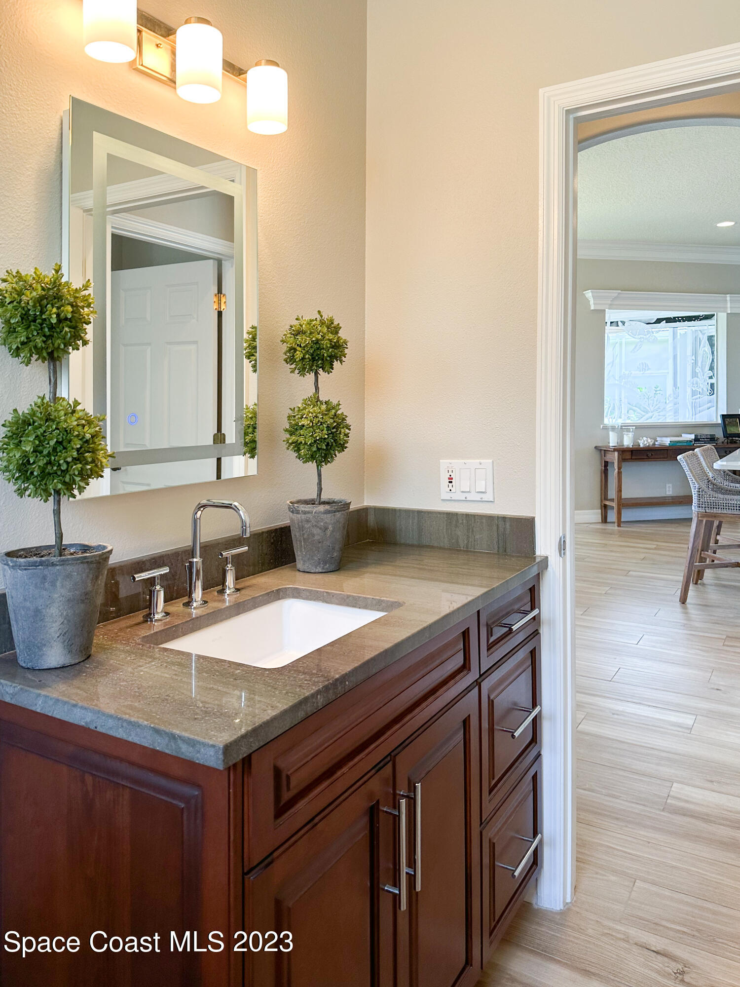 245 Clyde Street Melbourne Beach, FL 32951 - Photo 37 of 88 a bathroom with a granite countertop sink and a mirror