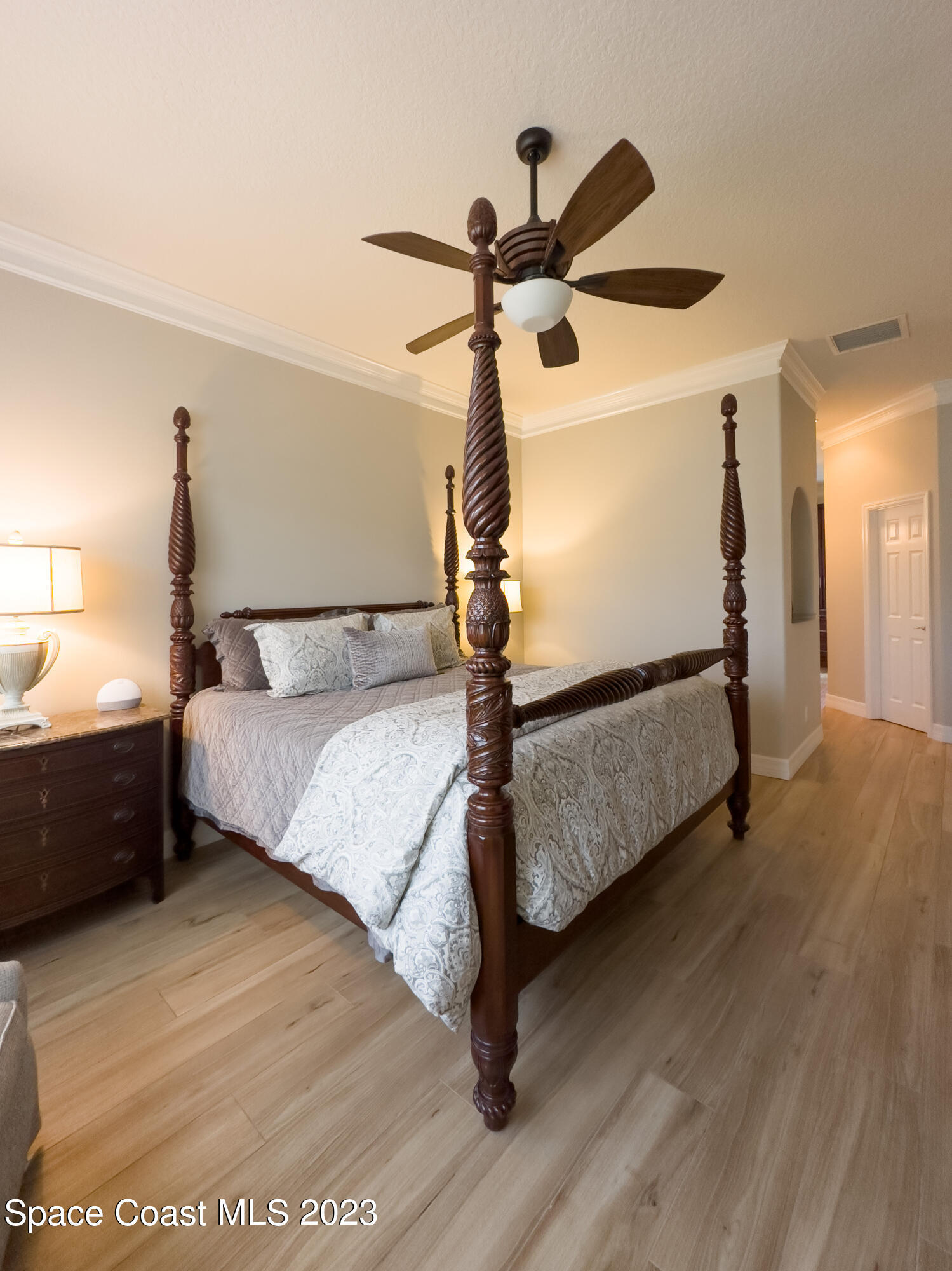 245 Clyde Street Melbourne Beach, FL 32951 - Photo 57 of 88 a bedroom with a bed and a chandelier