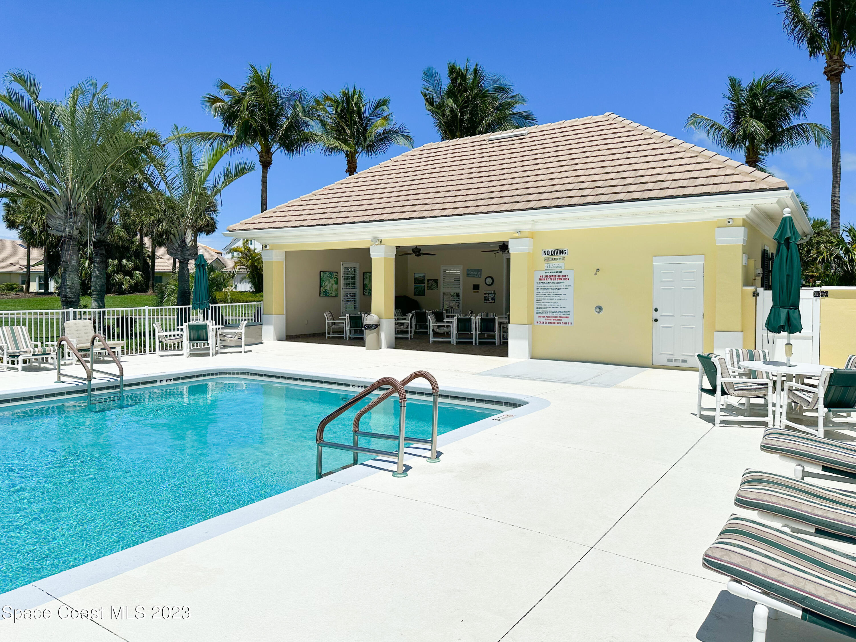 245 Clyde Street Melbourne Beach, FL 32951 - Photo 76 of 88 a view of a house with swimming pool and porch with furniture
