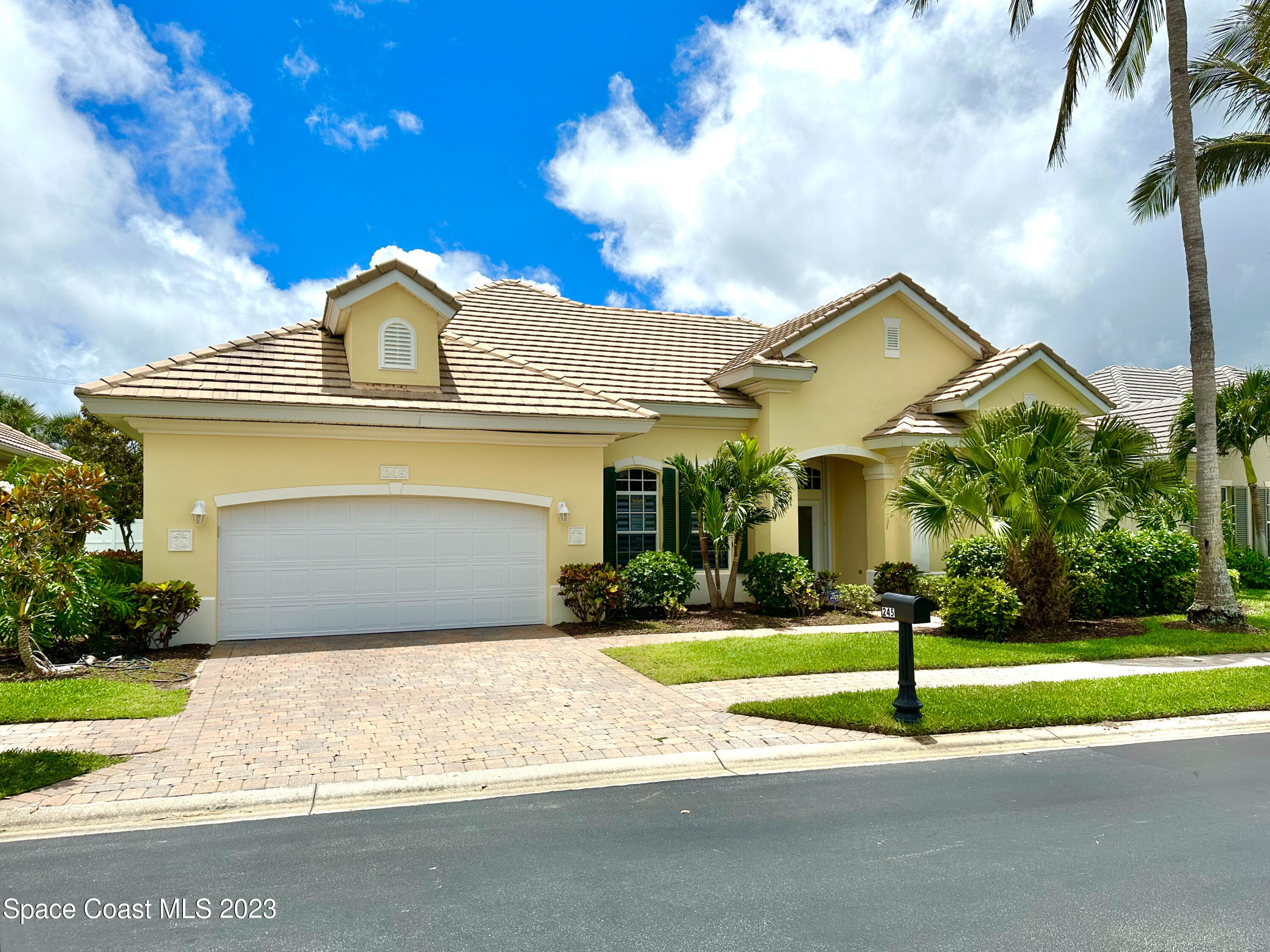 245 Clyde Street Melbourne Beach, FL 32951 - Photo 86 of 88 a front view of a house with a yard and garage
