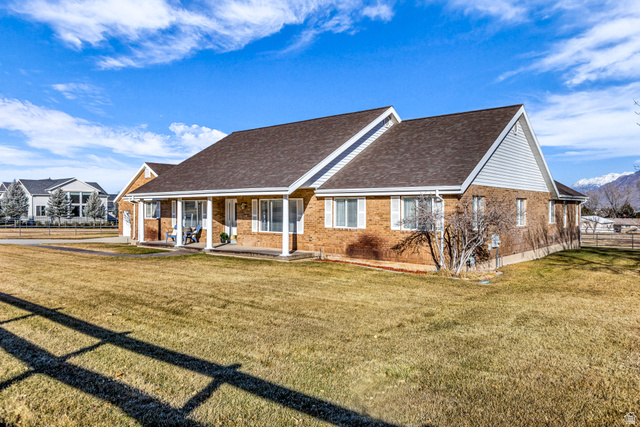 1060 West 2620th Street South Mapleton, UT 84664 - Photo 51 of 87 View of front of property with covered porch, roof with shingles, and brick siding