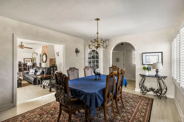 a view of a a dining room with furniture window and wooden floor