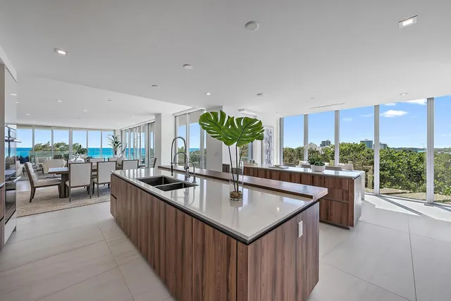 a kitchen with stainless steel appliances granite countertop a sink and a large window