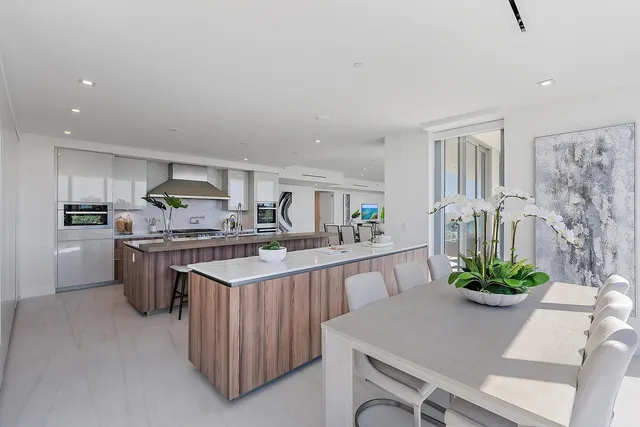 a kitchen with stainless steel appliances granite countertop a refrigerator a stove and a sink