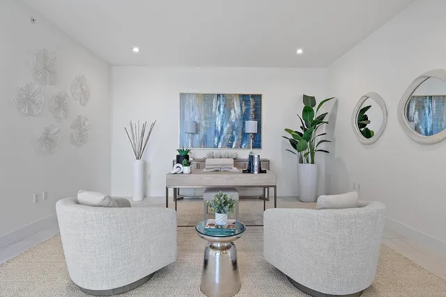 a living room with furniture and a potted plant