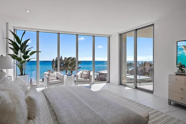 a living room with furniture and large windows