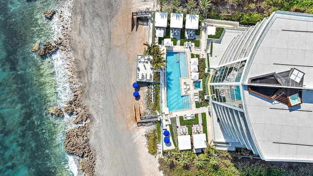 an aerial view of residential house with outdoor space and seating area