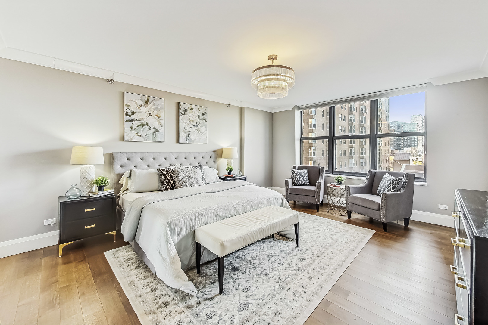 55 West Delaware Place, Unit 620 Chicago, IL 60610 - Photo 24 of 48 a spacious bedroom with a bed and a large window