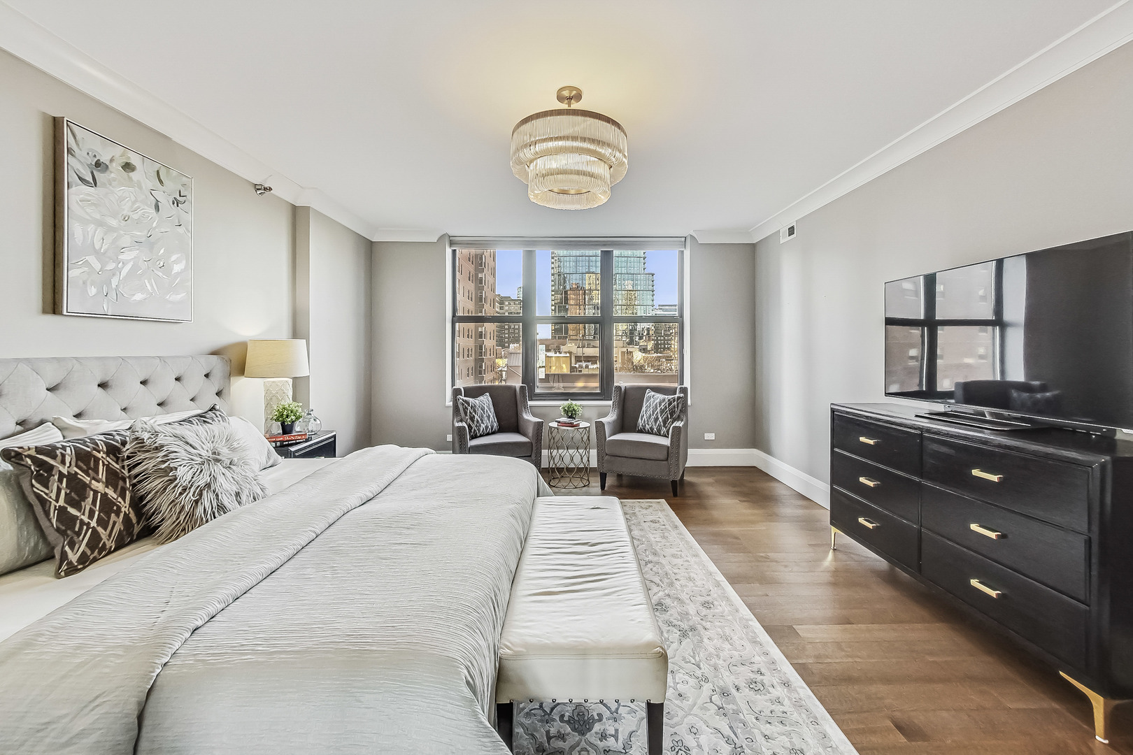 55 West Delaware Place, Unit 620 Chicago, IL 60610 - Photo 26 of 48 a spacious bedroom with a bed and furniture with window
