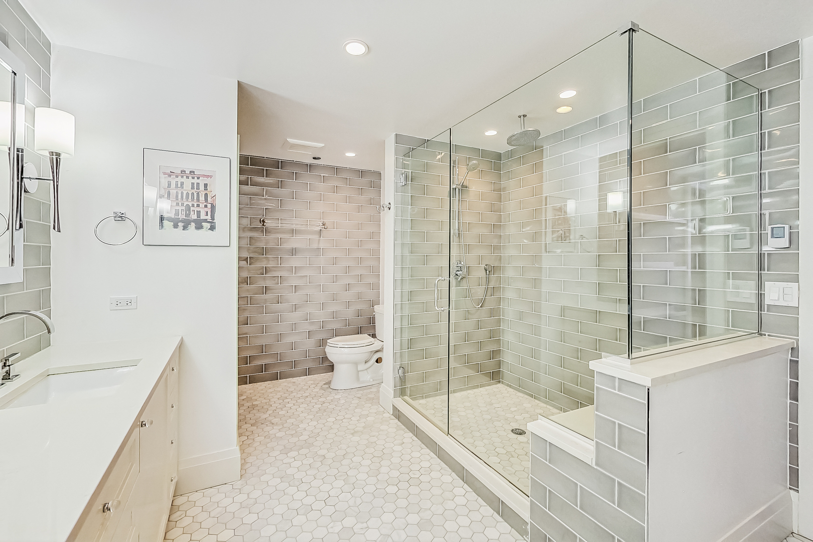 55 West Delaware Place, Unit 620 Chicago, IL 60610 - Photo 28 of 48 a bathroom with a double vanity sink toilet and shower