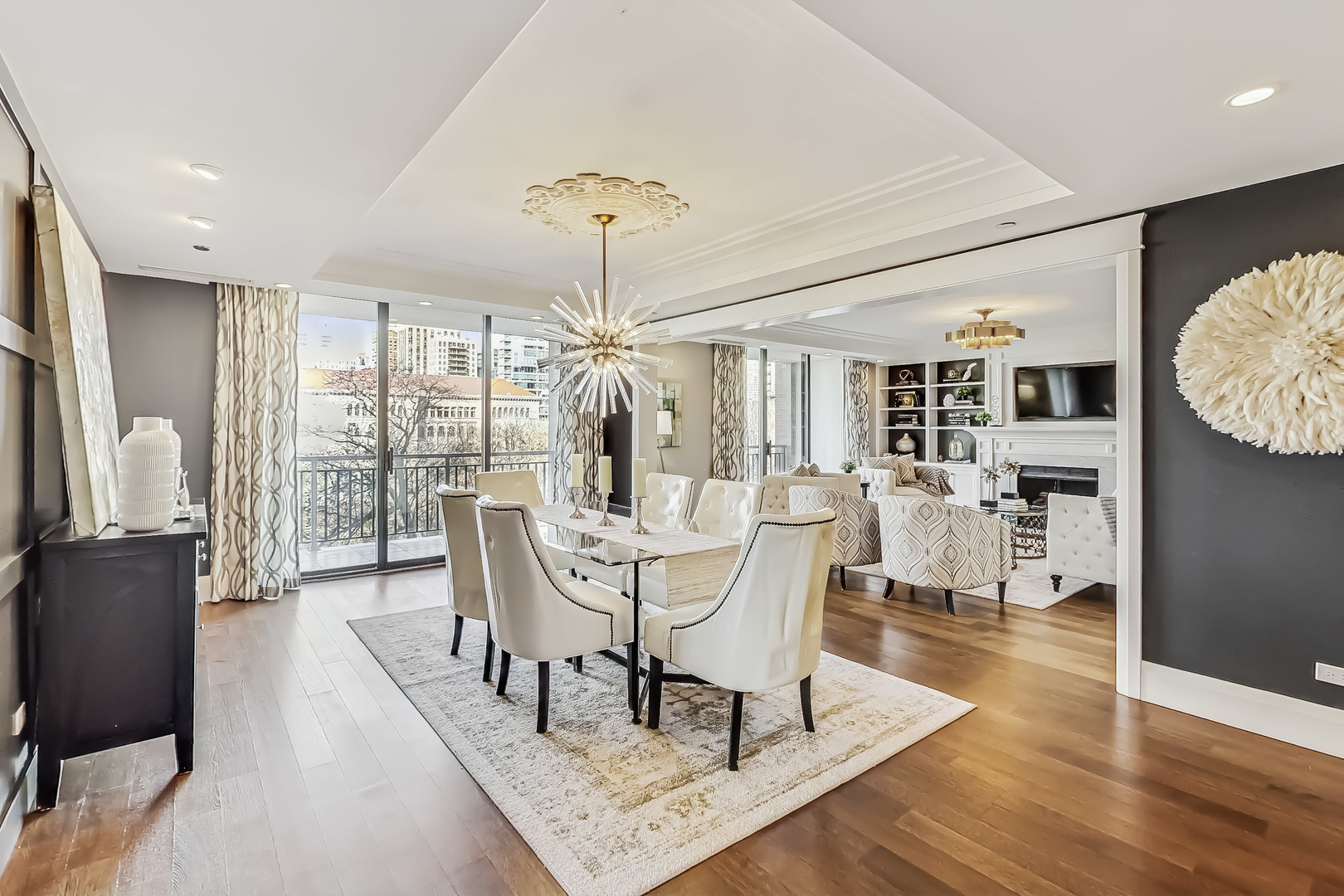55 West Delaware Place, Unit 620 Chicago, IL 60610 - Photo 3 of 48 a dining room with furniture a chandelier and wooden floor