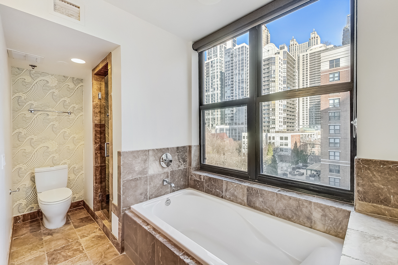 55 West Delaware Place, Unit 620 Chicago, IL 60610 - Photo 32 of 48 a bathroom with a bathtub and a large window